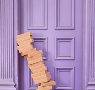 pile of brown boxes beside purple wooden wall