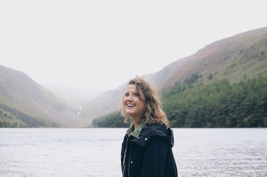 woman in front of body of water in Glendalough Ireland