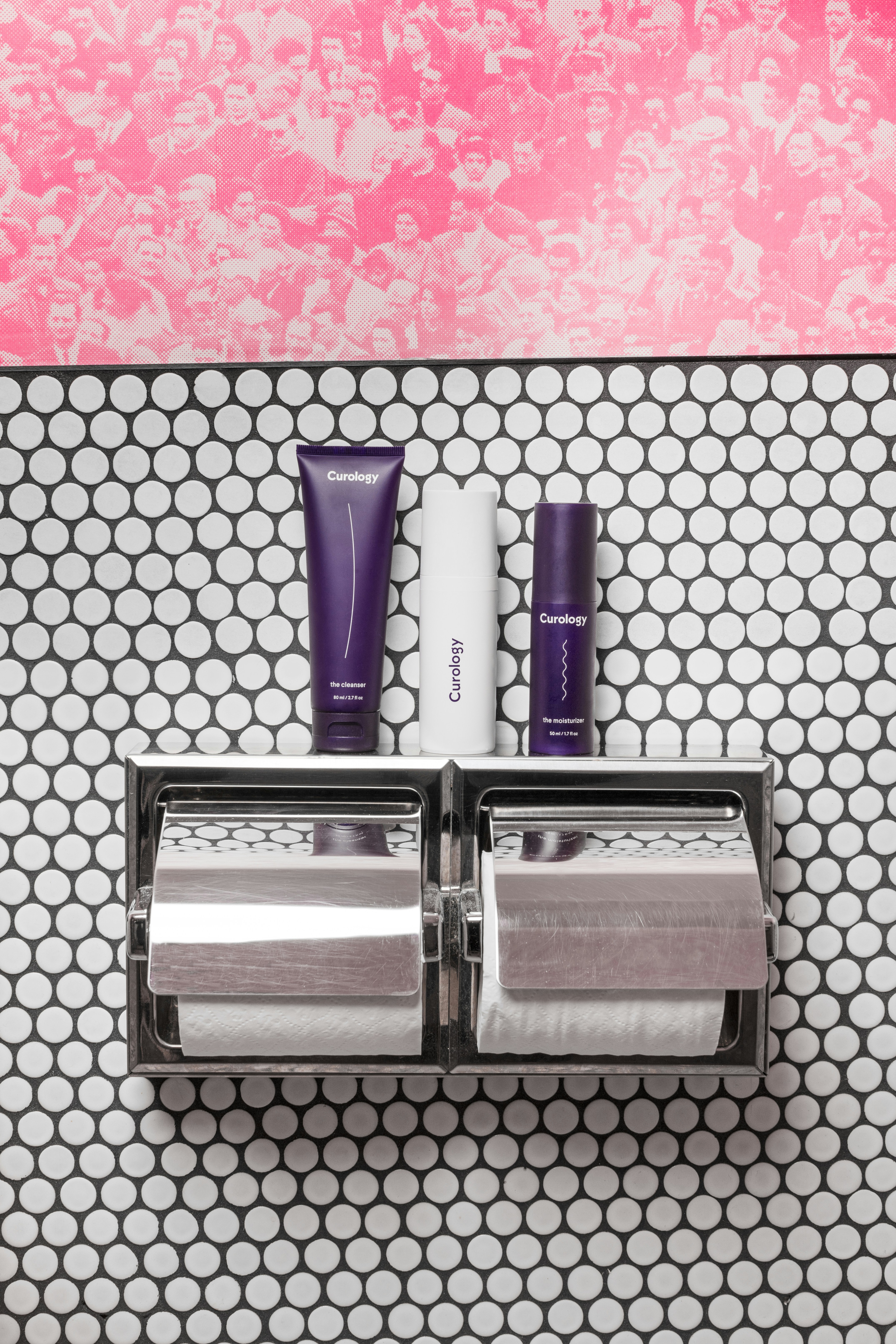 purple and white soft-tube and bottles on toilet paper rack