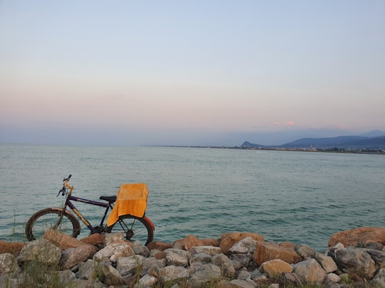 bike parks at rocks near body of water in Ramsar Iran