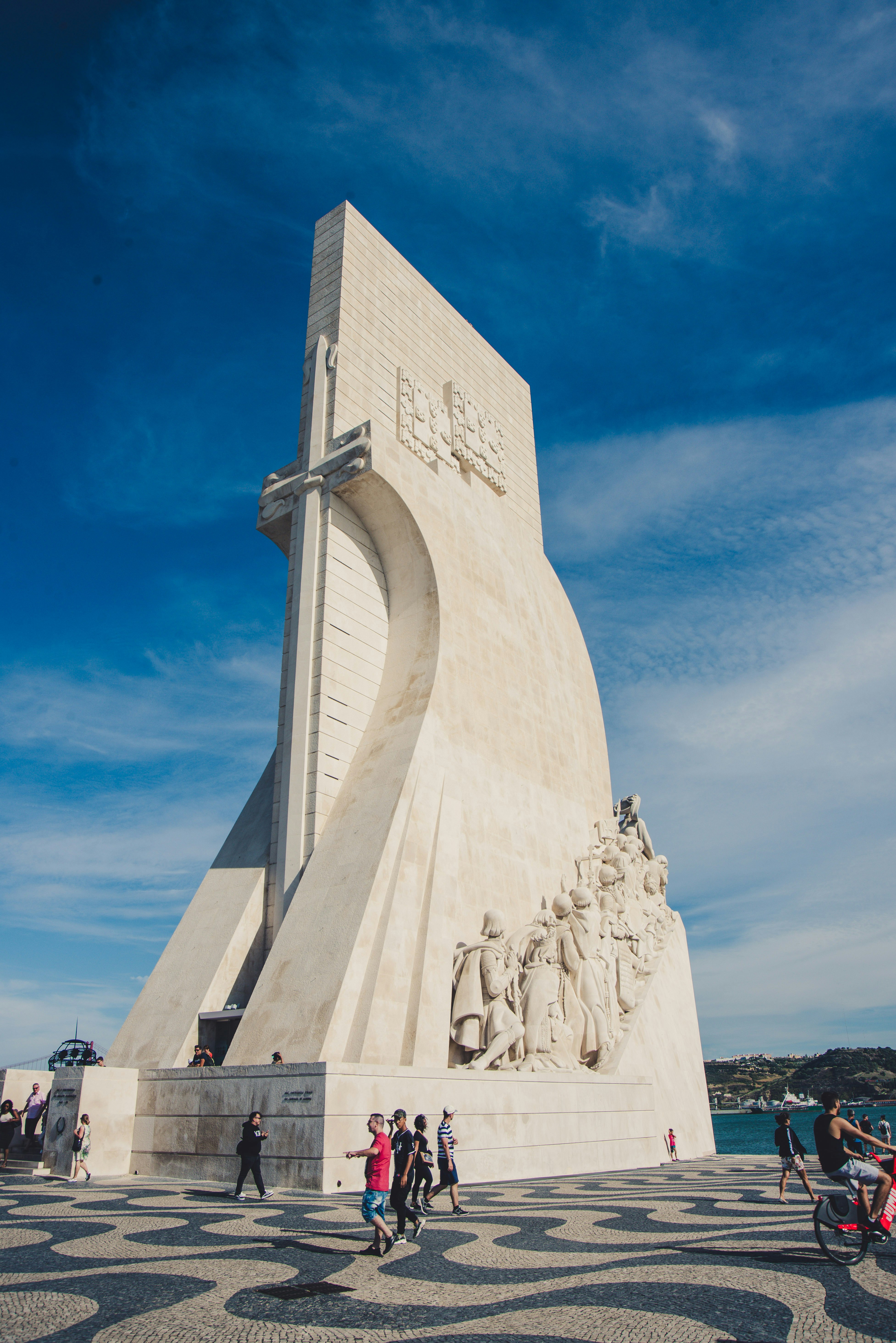 people near white monument under blue and white sky during daytime