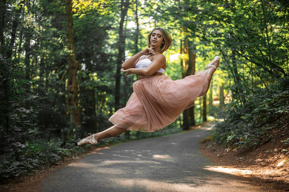 woman jumping on road