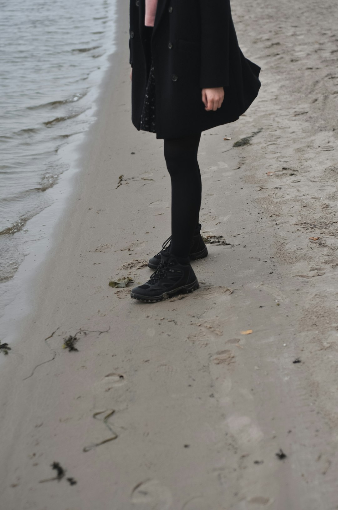 person stands near shore