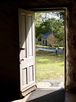 opened white 4-panel door