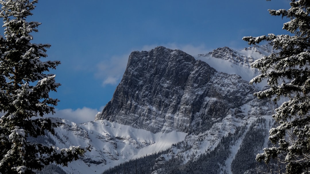 snow covered mountain under cloudy sky