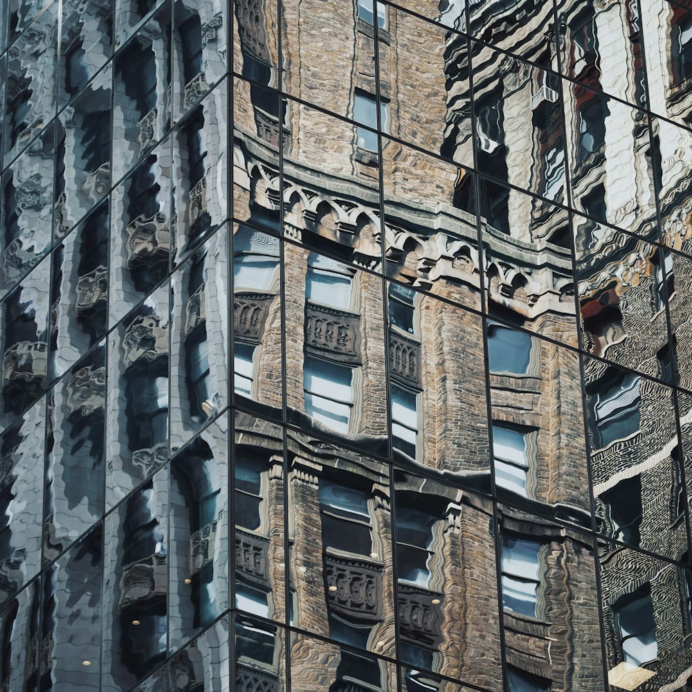 a reflection of a building in the windows of another building