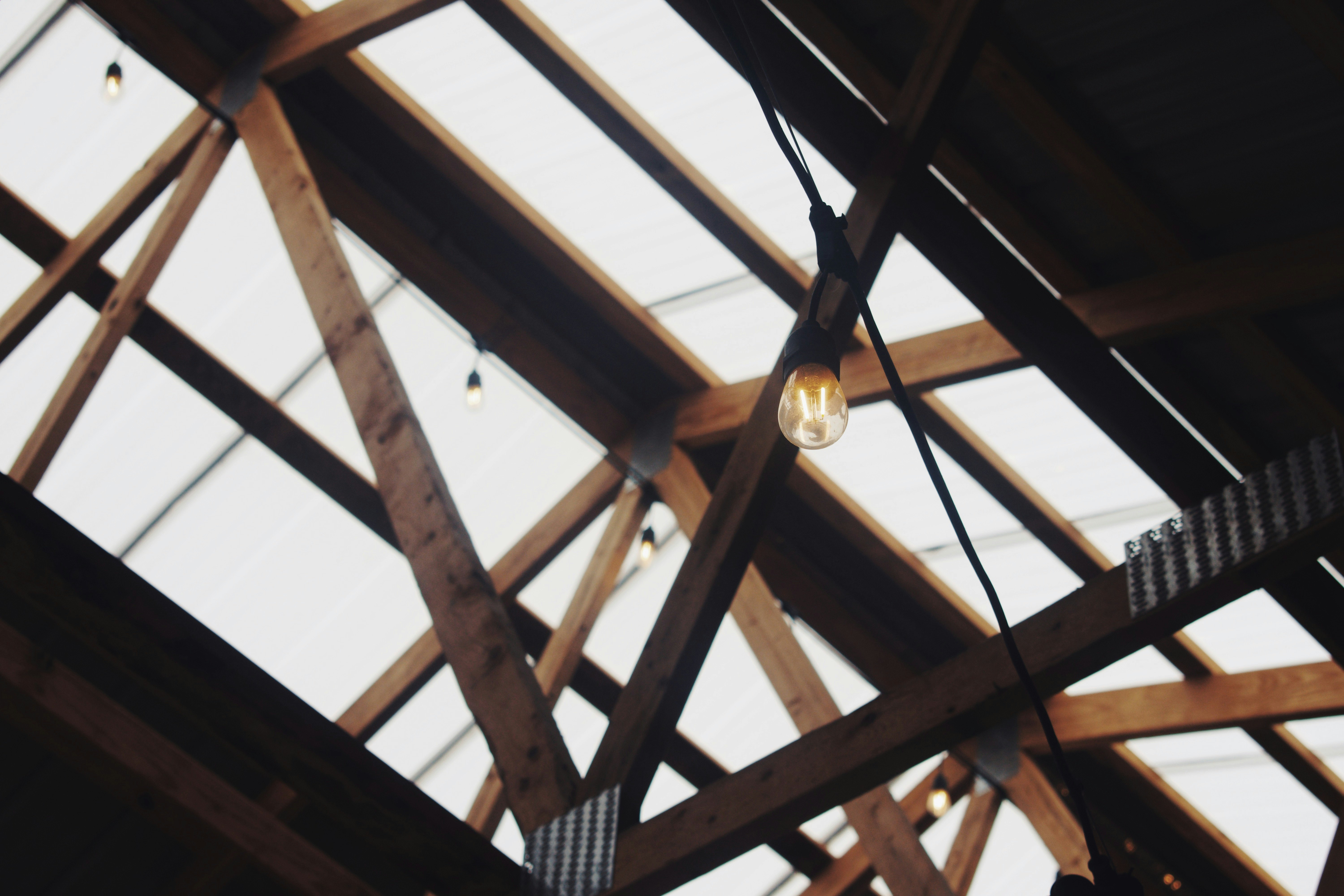 brown wooden truss with clear roof