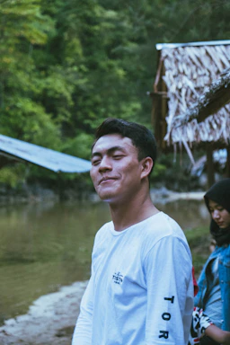 A friendly person holding a clipboard near a clear river in Mexico