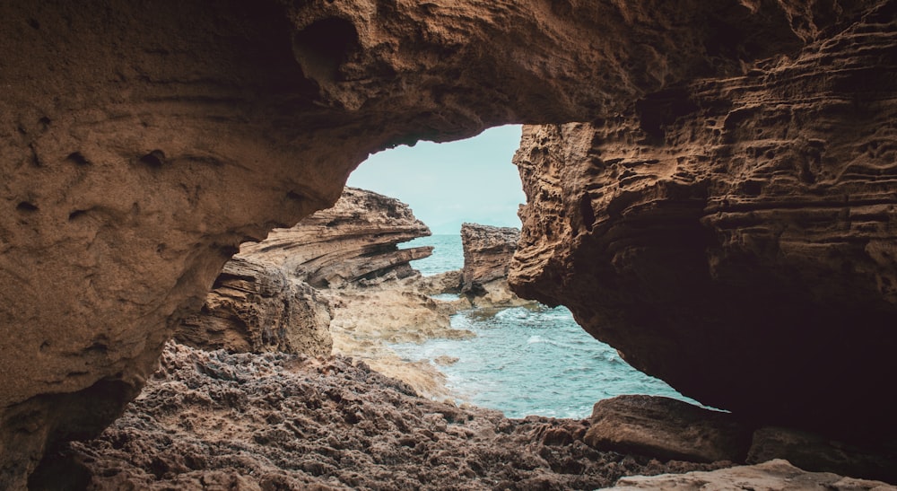 rocky cave island during day