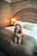 A cozy pet bed in a stylish living room setting with a happy dog.