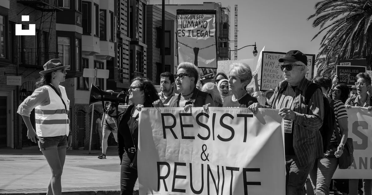 Grayscale photography of crowd of people rallying on street near ...