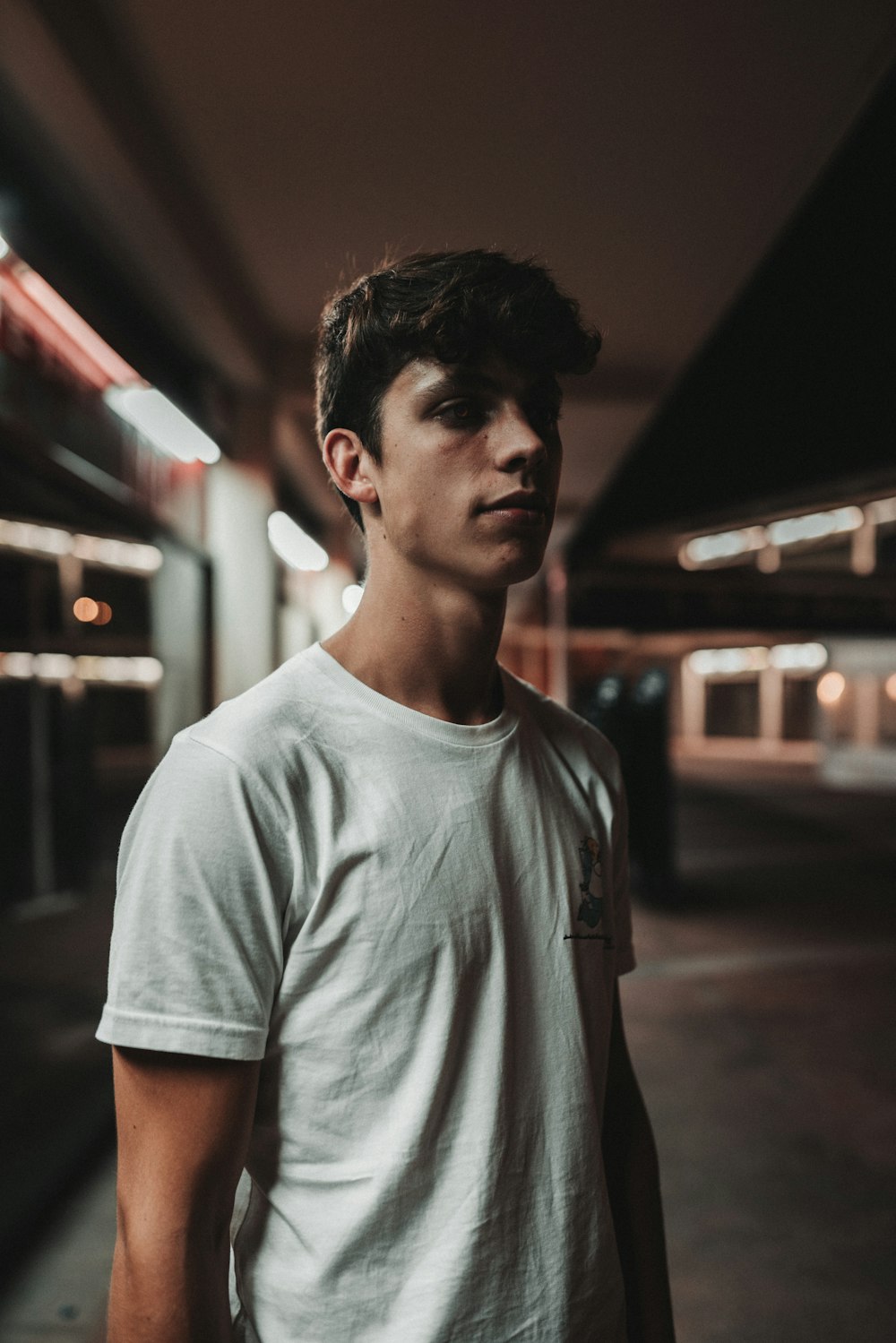 standing man wearing white crew-neck t-shirt