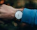 Close-up of a wrist wearing a minimalist md tertius watch with a soft natural light background.
