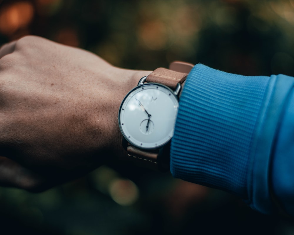 round silver-colored analog watch