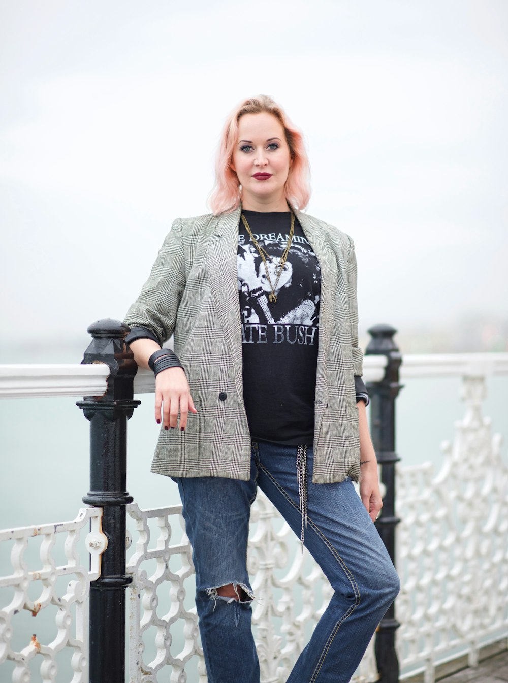 woman by a white and black metal fence