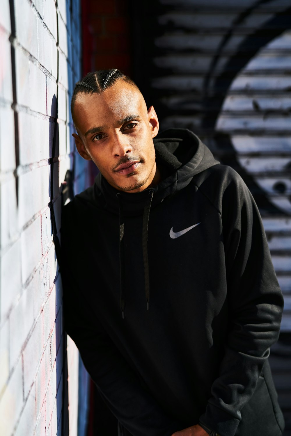 man wears black Nike pullover hoodie