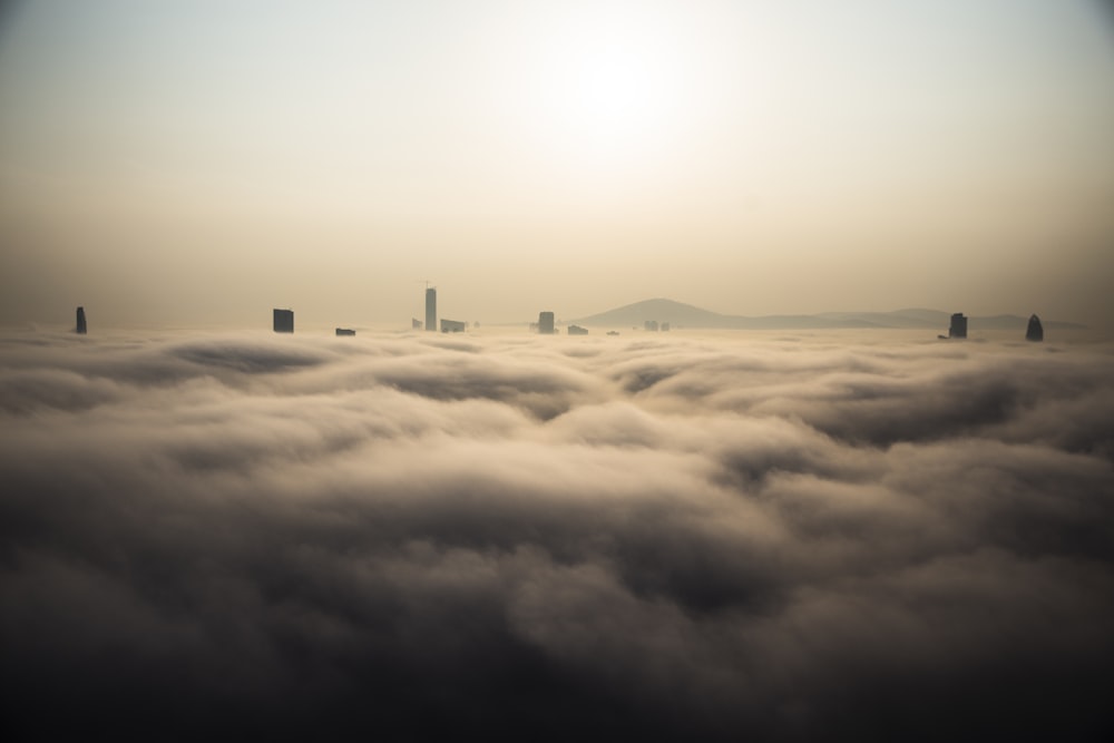 high-rise building covered with clouds