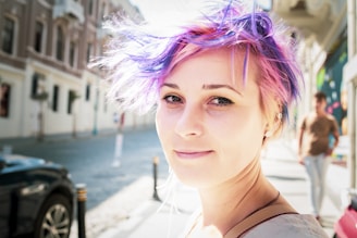 Farzaneh smiling warmly on a sunlit city street, capturing her vibrant spirit.