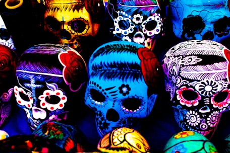 A collection of colorful resin ashtrays with skull designs.