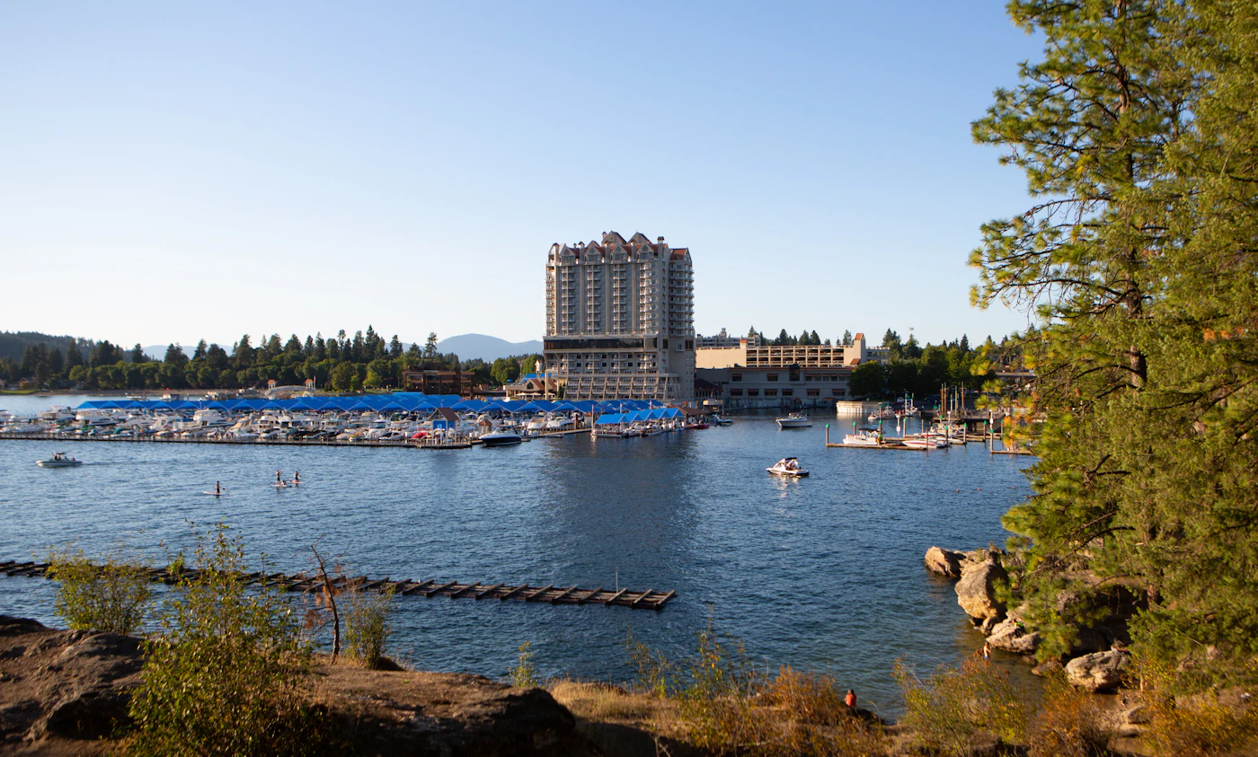 The blue water of Lake Coeur d'Alene with the resort tower on the shoreline