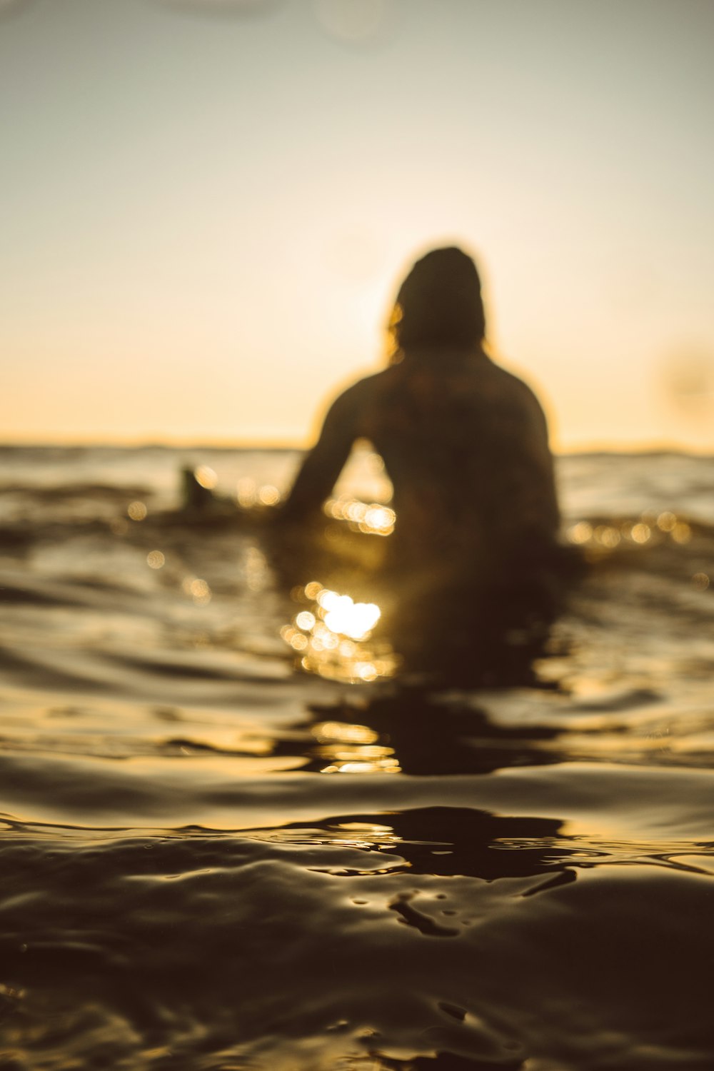 silhouette of person riding surfboard