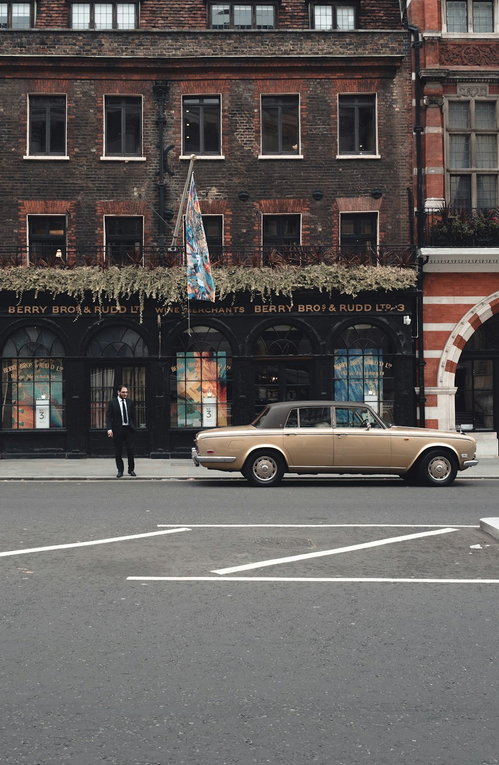 brown sedan parked on road during daytime