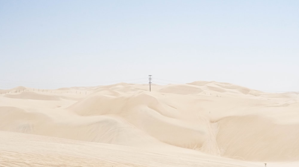 a person riding a horse in the middle of a desert