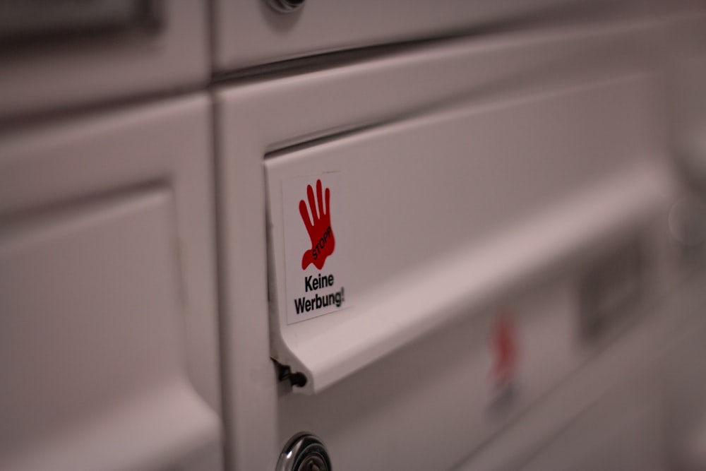 white sticker on white wooden drawer