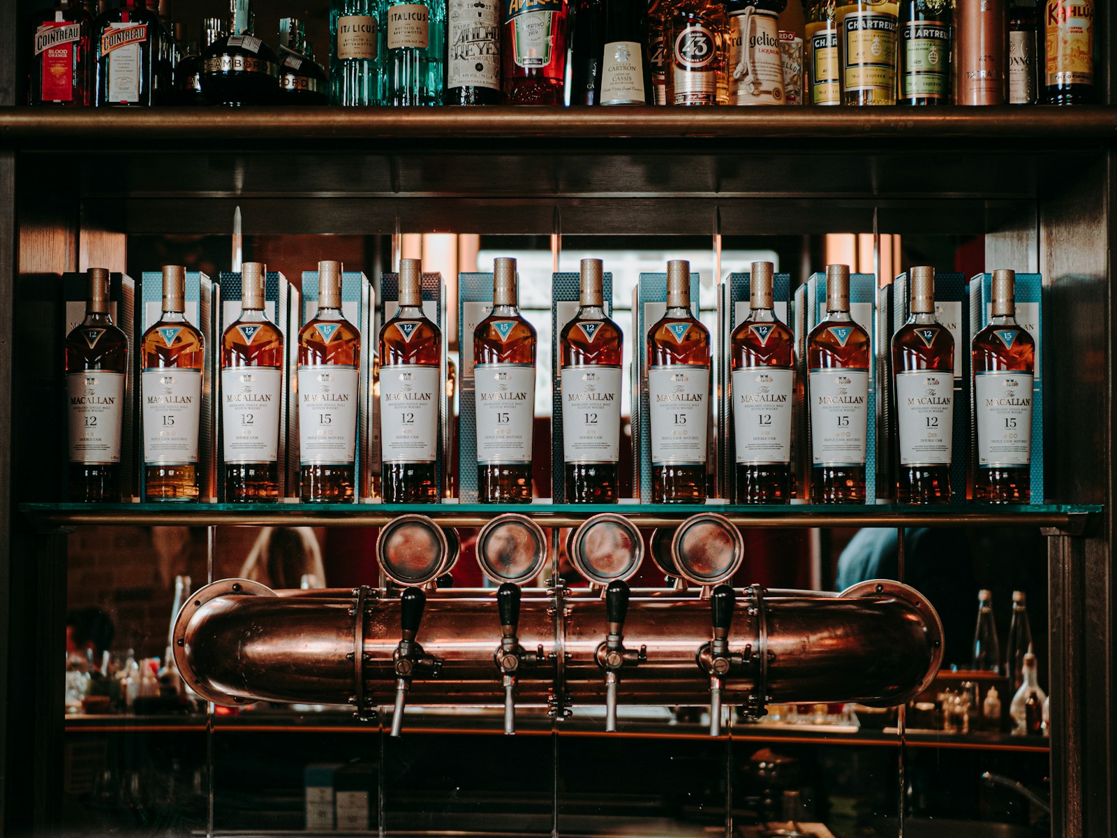 OLYMPUS M.25mm F1.2 sample photo. Liquor bottles on shelf photography