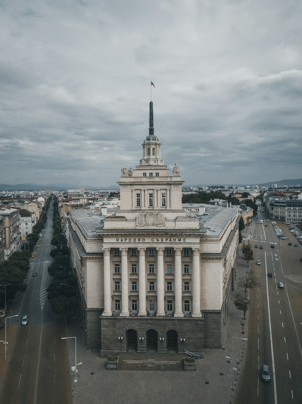 white and gray concrete building under cloudy sky