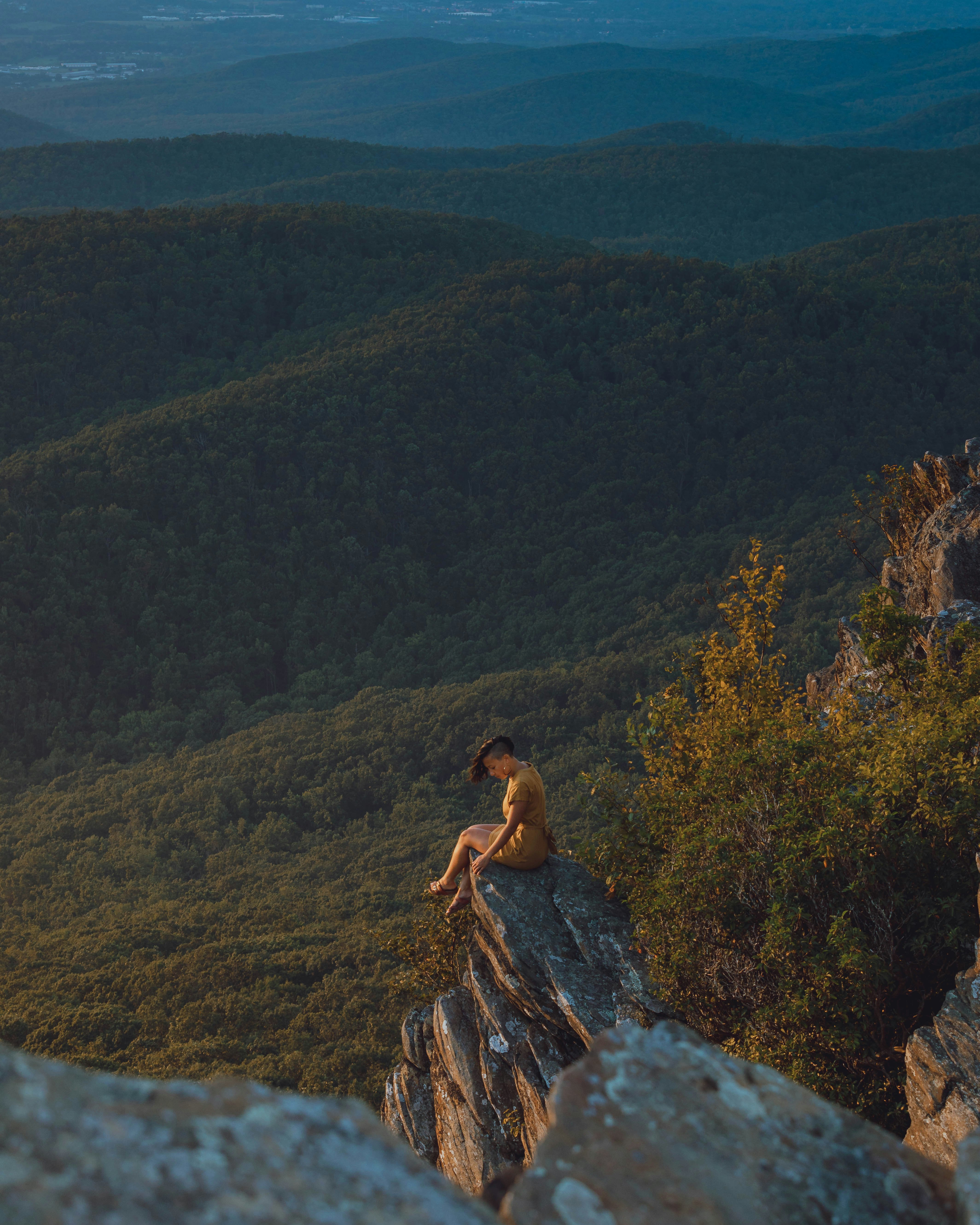 woman sitting on rock formation