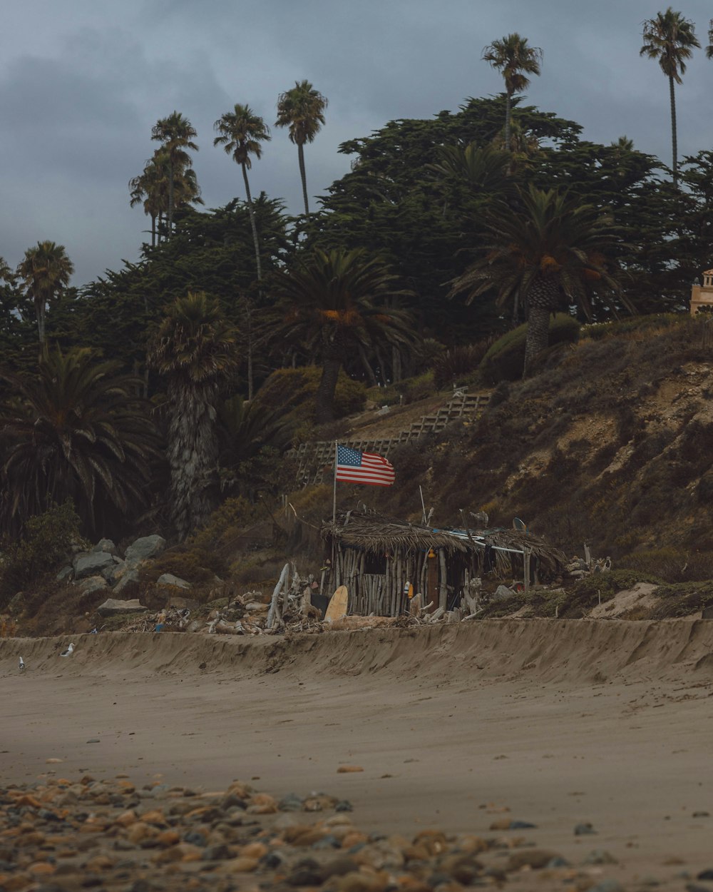 US flag on seashore during daytime