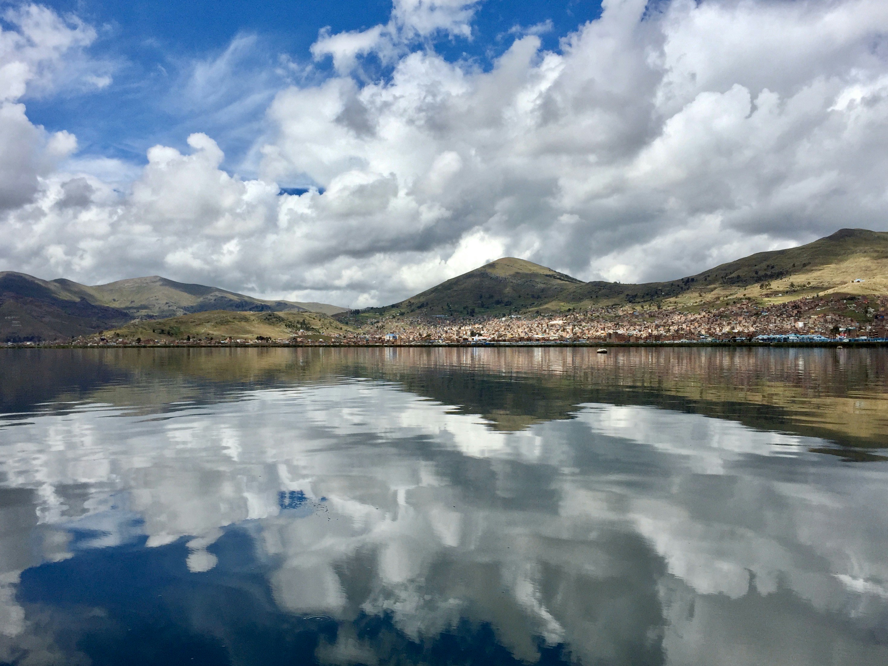 photography of body of water and mountain range during daytime