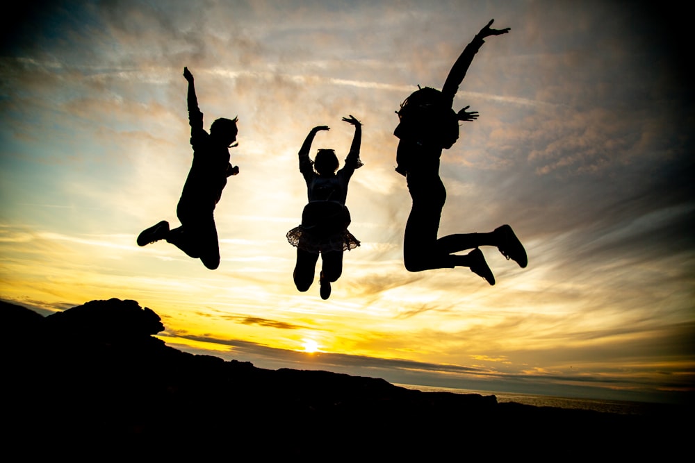 silhouette of jumping people