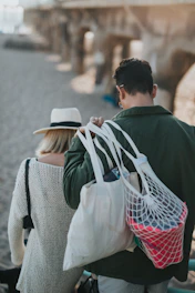 man carrying white bags