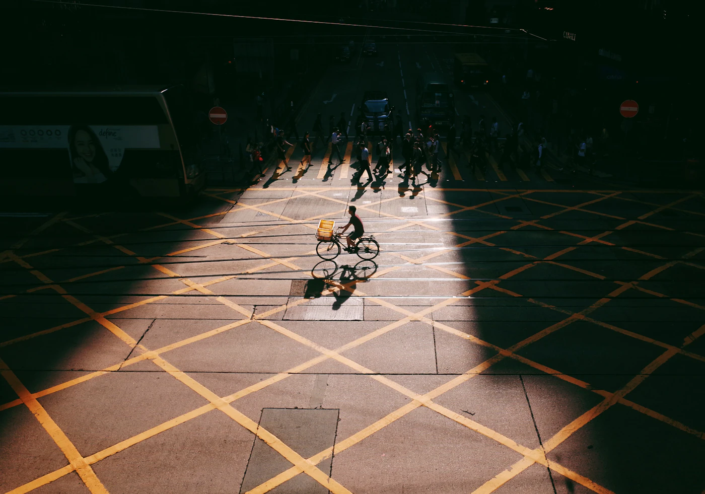 Cyclist moving through dramatic light and shadow