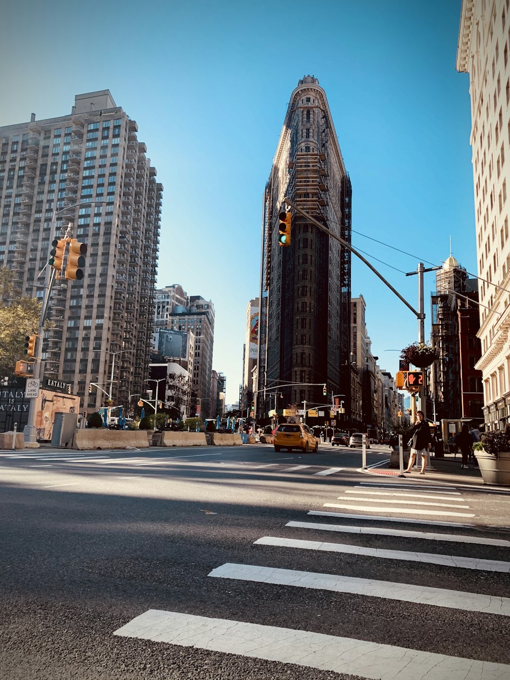 people walking on pedestrian lane near high rise buildings during daytime