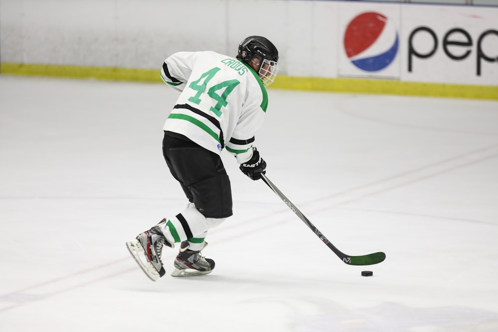 photography of man playing hockey