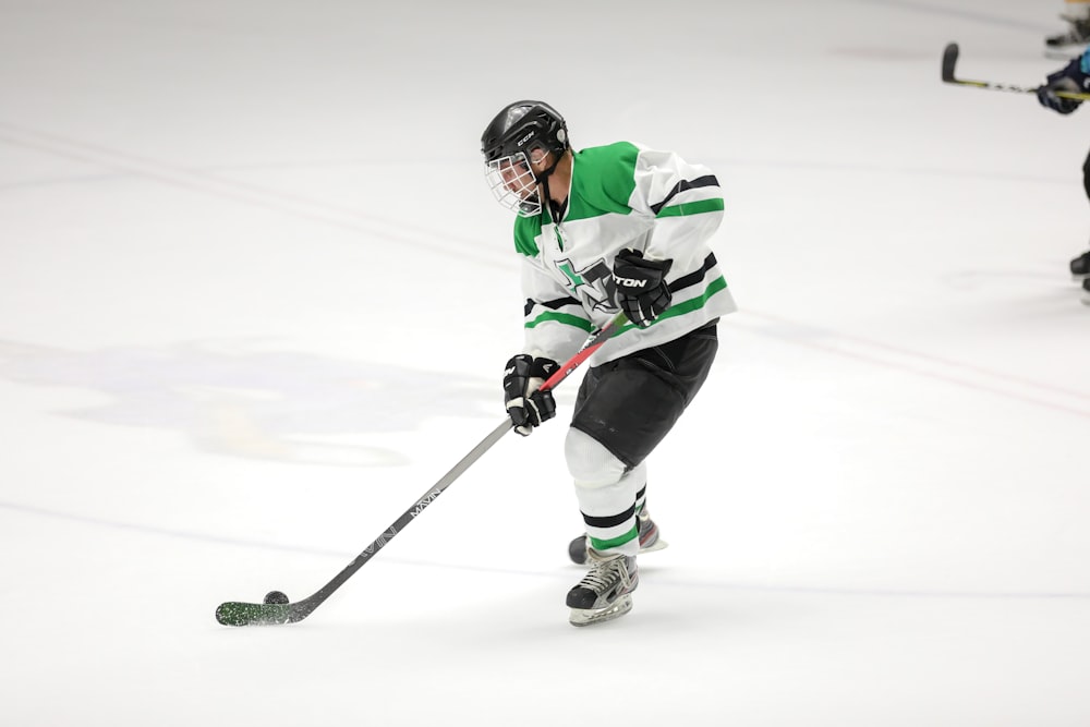 hockey player in green and white jersey