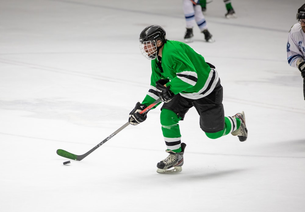 photography of man in green jersey shirt playing hockey