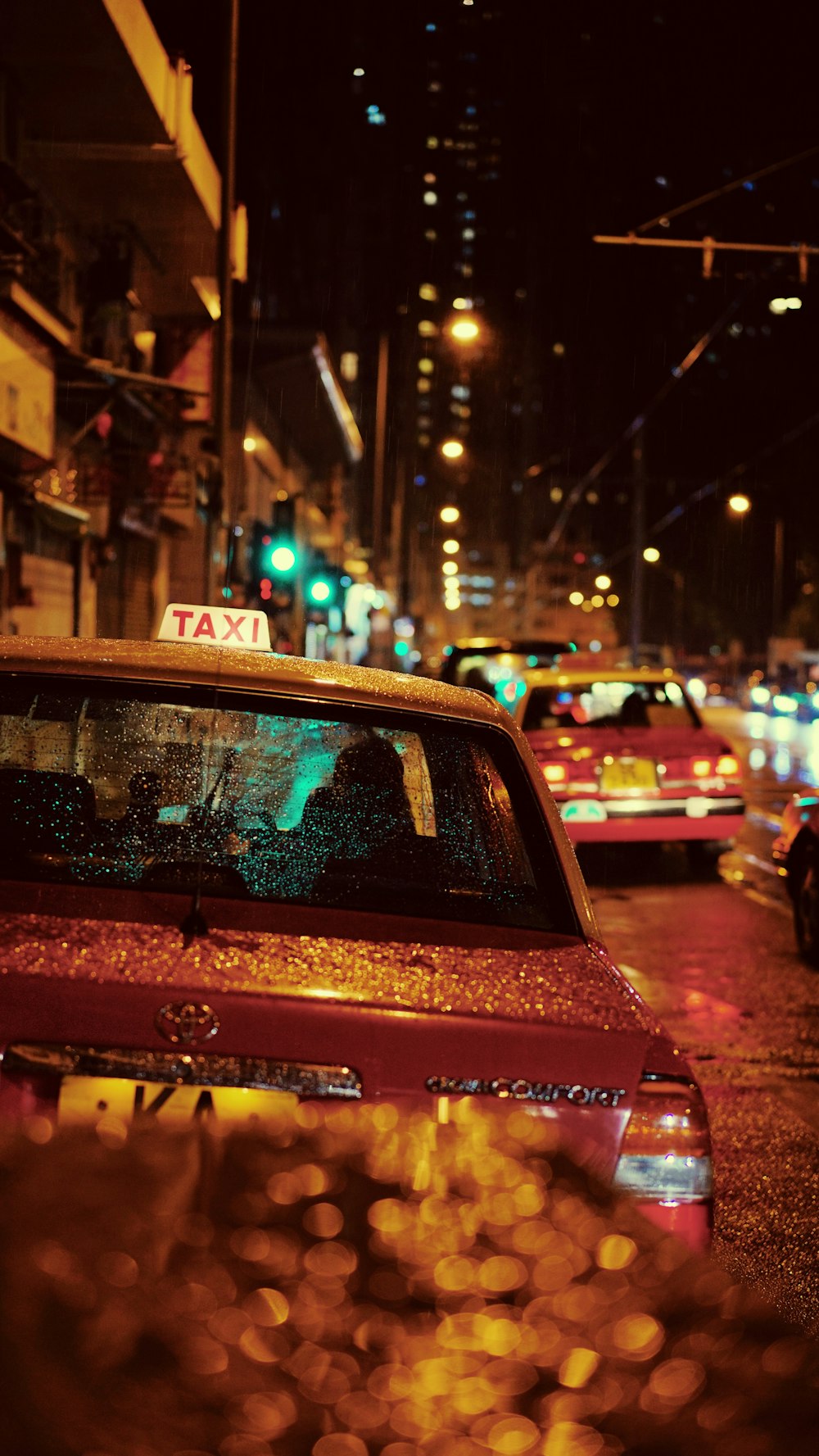 red Taxi parked beside road