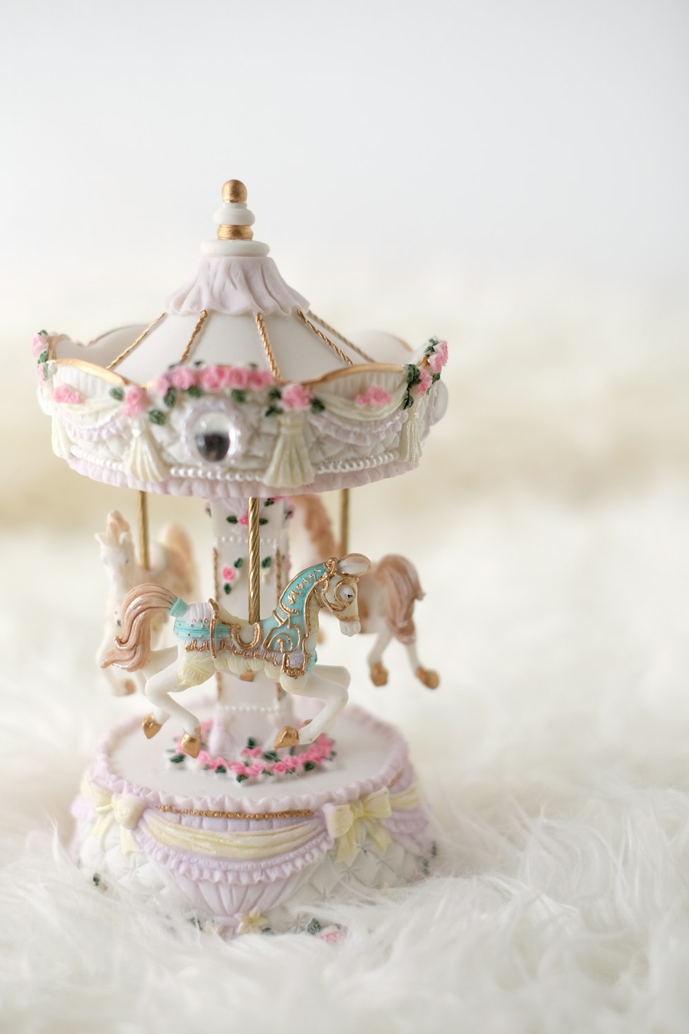 white and multicolored carousel figurine