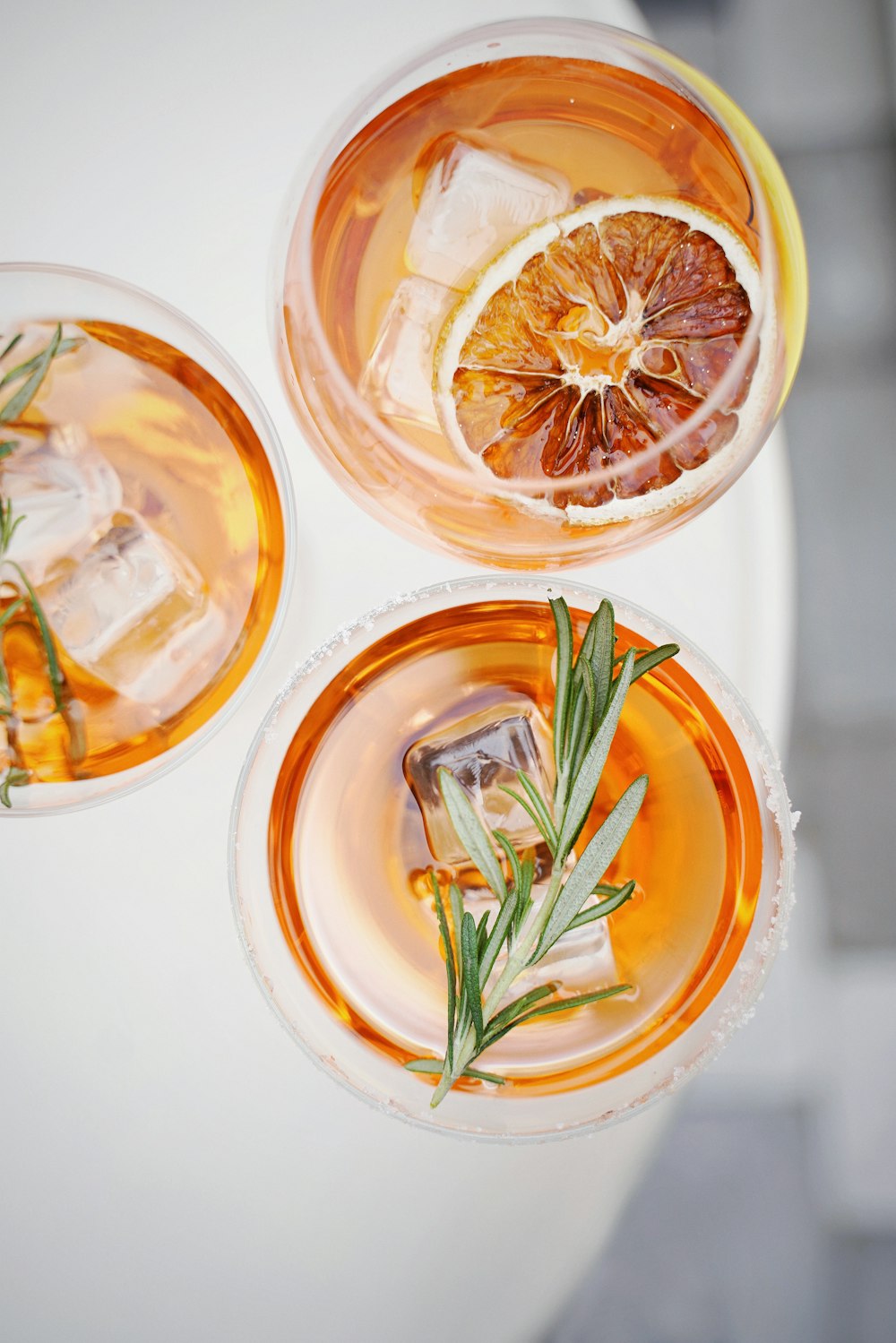 four glass cups on white surface