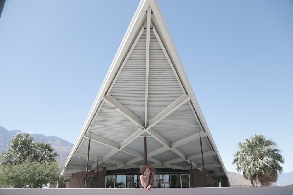 woman near white concrete building