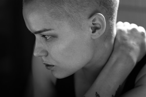 Close-up of a black and gray portrait tattoo with subtle shading.