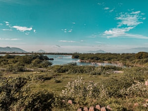 A serene landscape showcasing a picturesque travel destination with clear blue skies and lush greenery.
