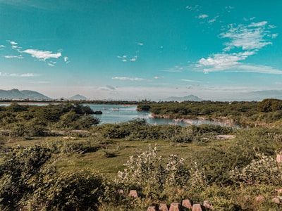 A serene landscape showcasing a picturesque travel destination with clear blue skies and lush greenery.