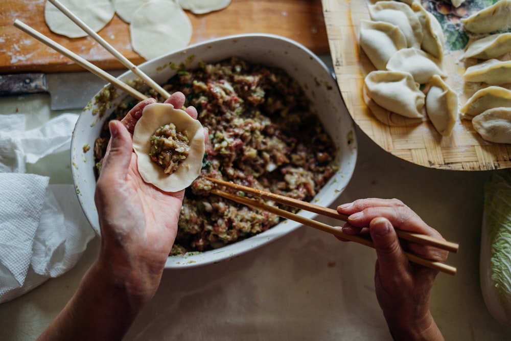 person making dumplings