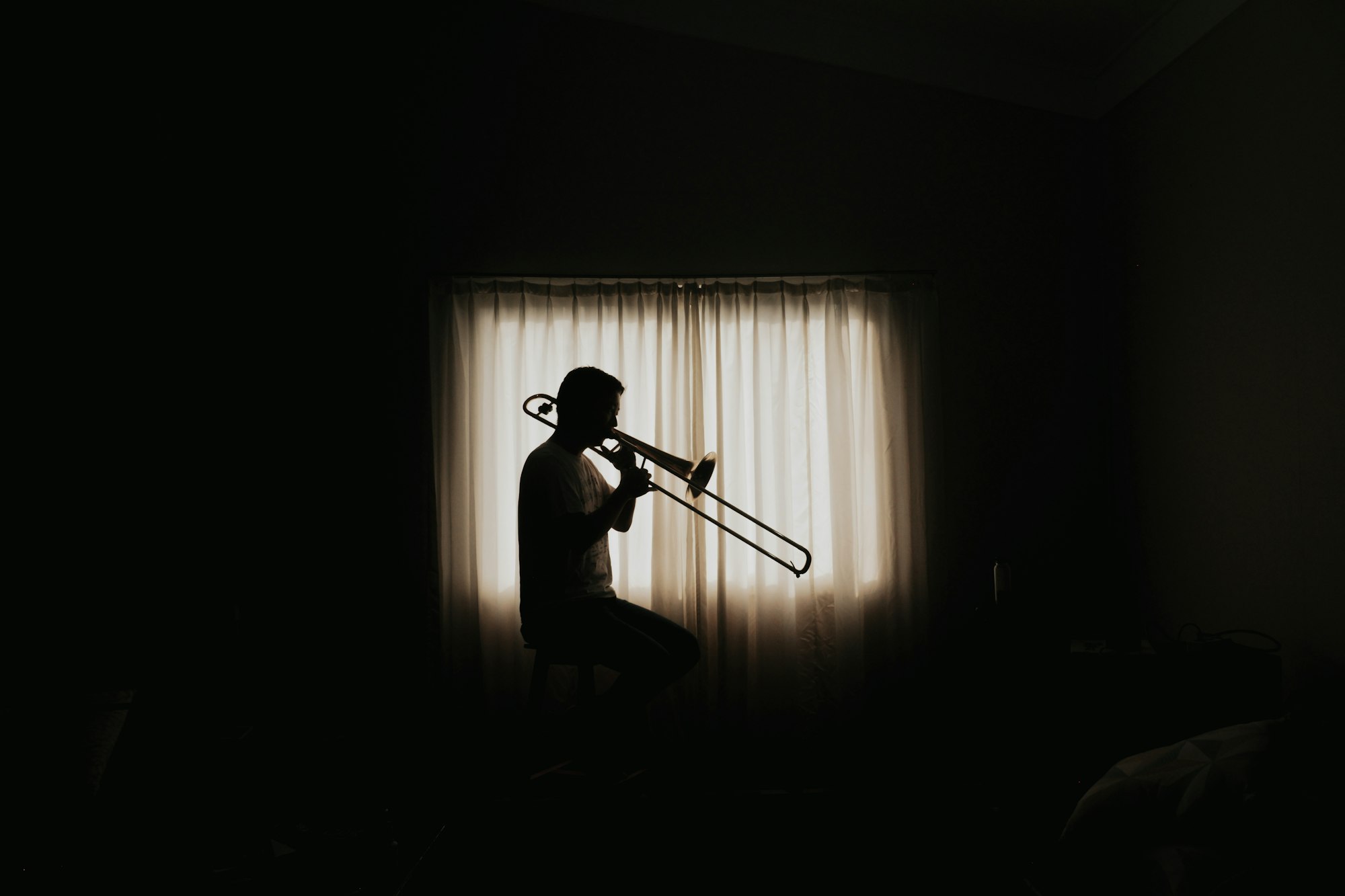 man playing wind instrumend inside room