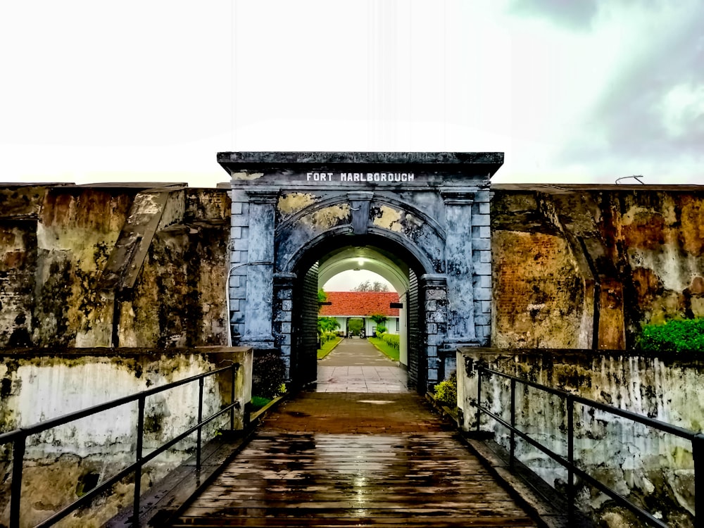 concrete archway under a white sky